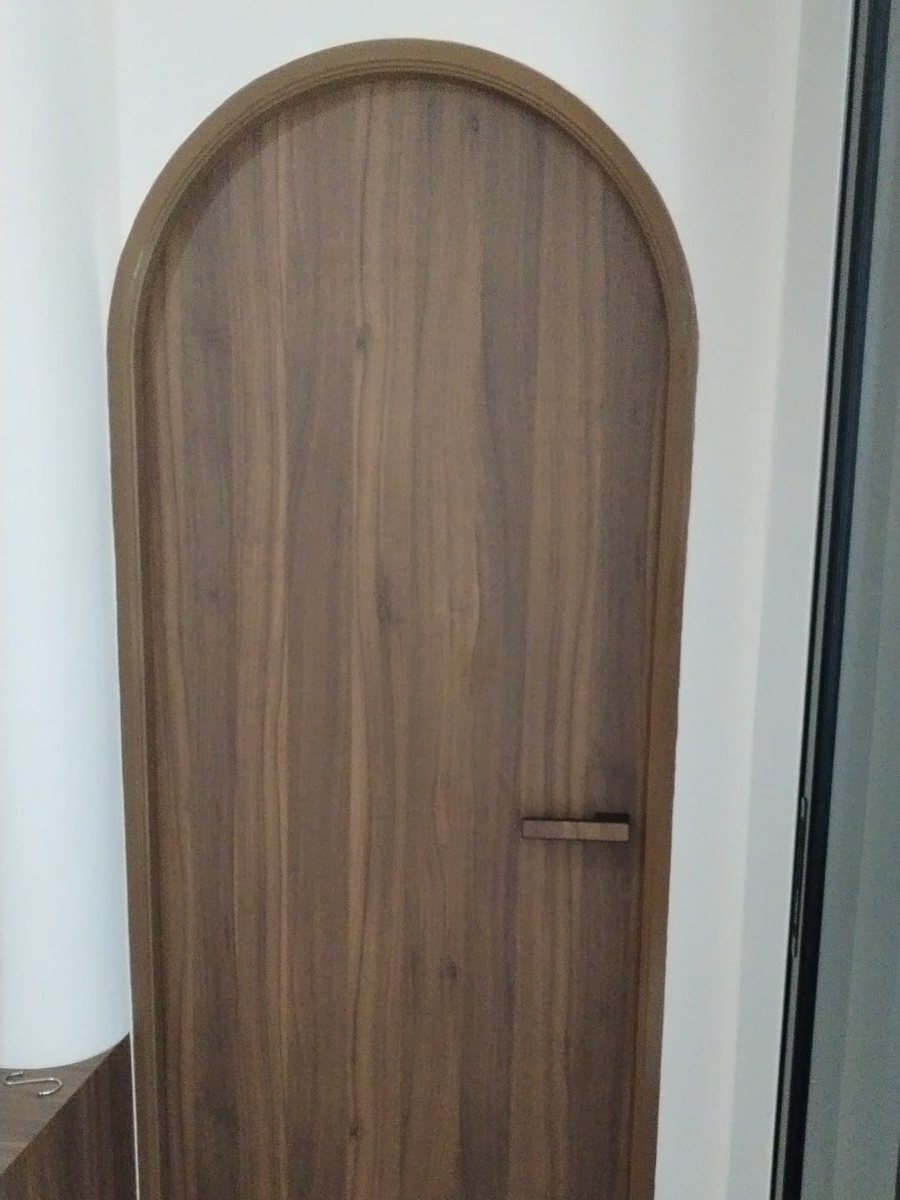 Arched walnut bedroom door, installed by Door Empire Singapore