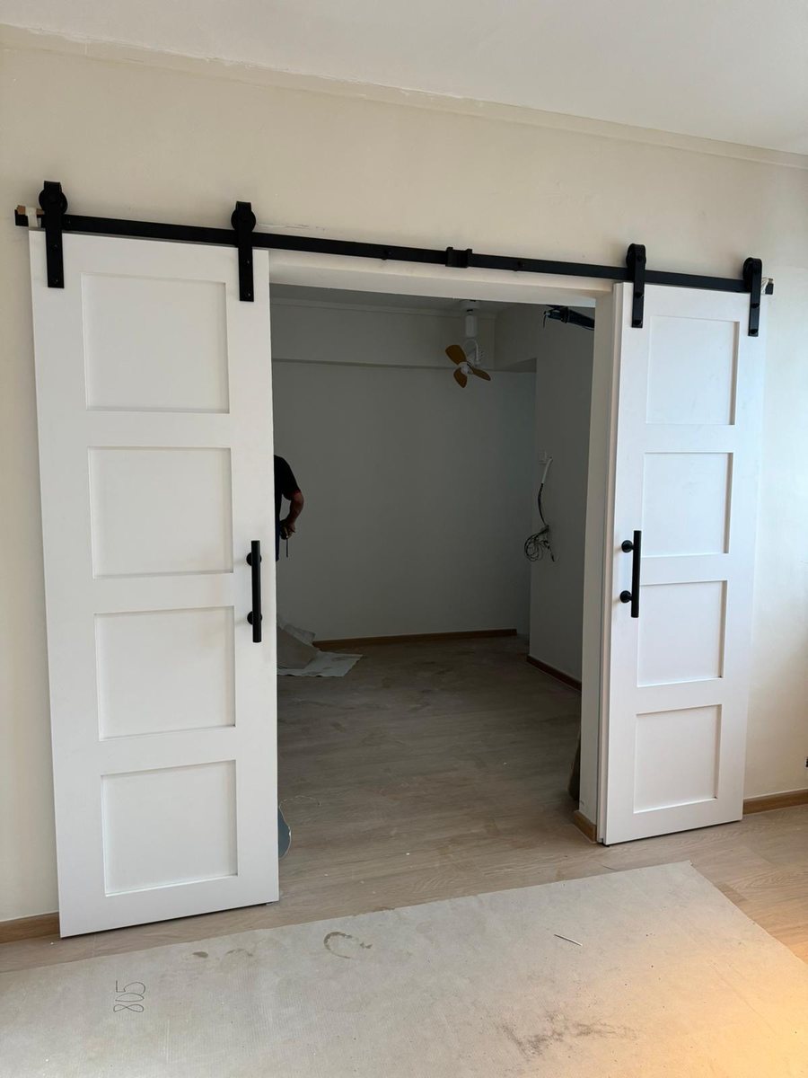 White barn-style sliding doors, installed by Door Empire Singapore