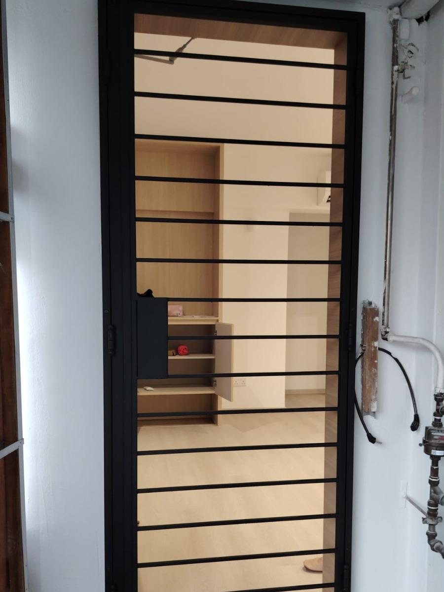 Horizontal slat gate in white corridor, installed by Door Empire Singapore