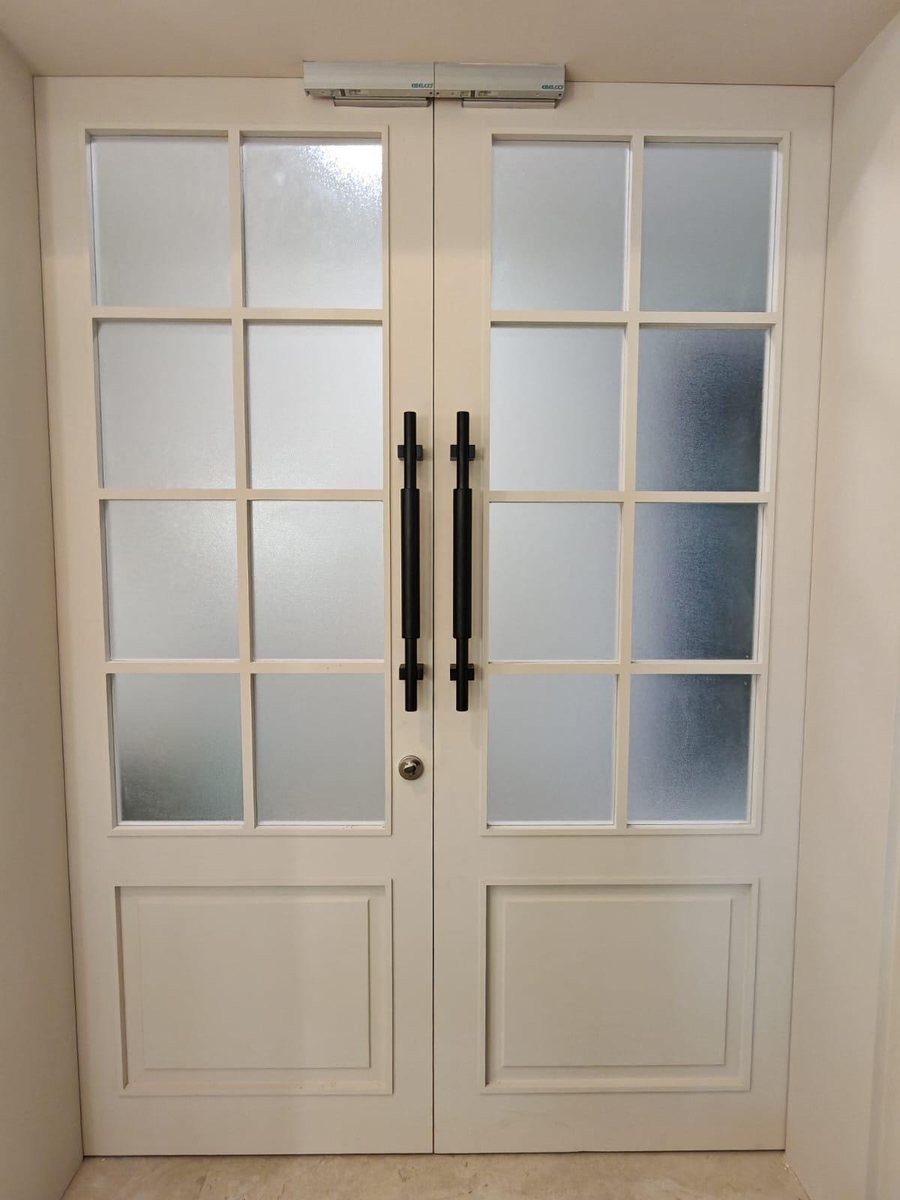 White double main door with glass panes, installed by Door Empire Singapore