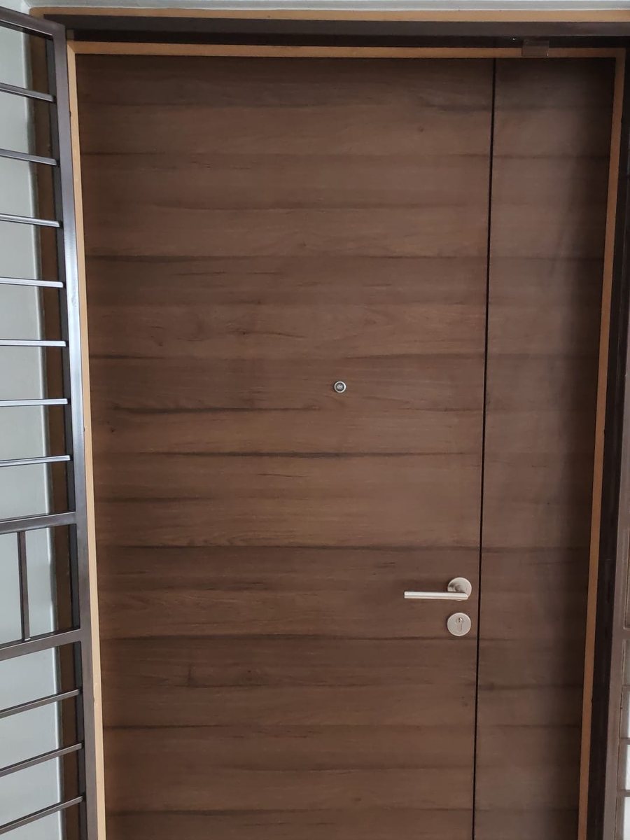 Vertical wood-grain fire-rated main door, installed by Door Empire Singapore